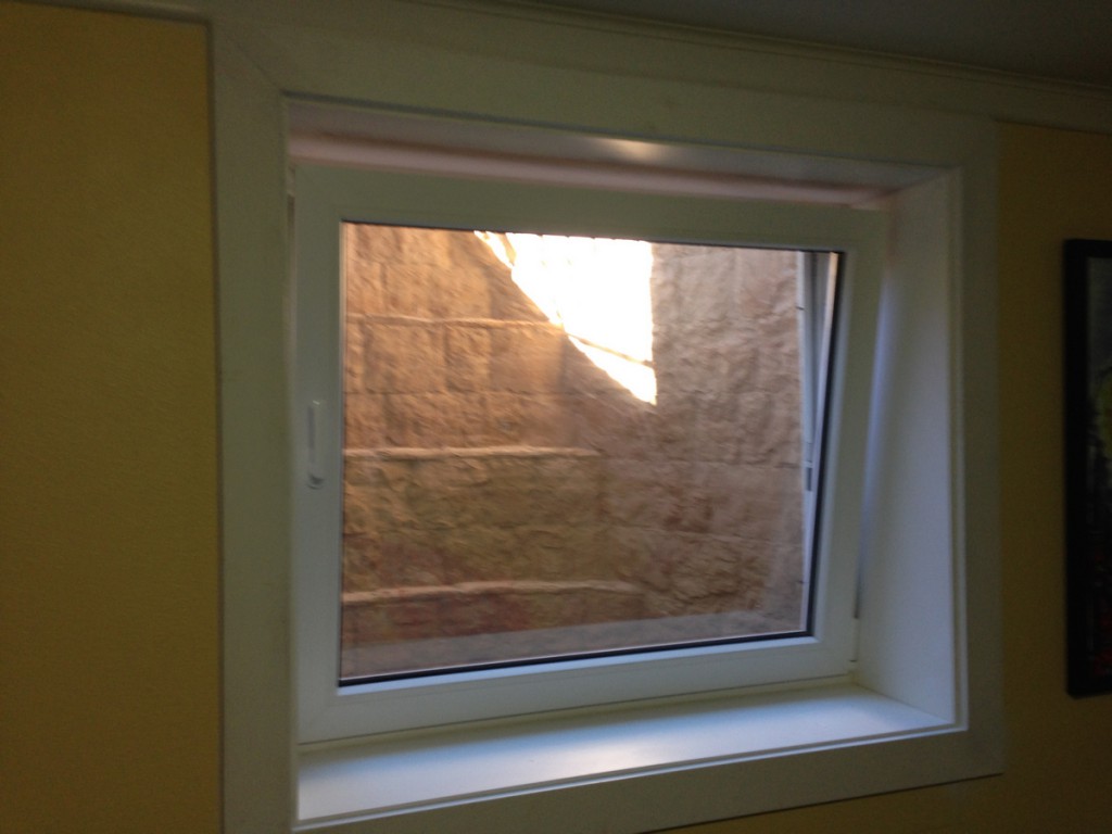 Tilt and turn egress window open inward in a finished basement