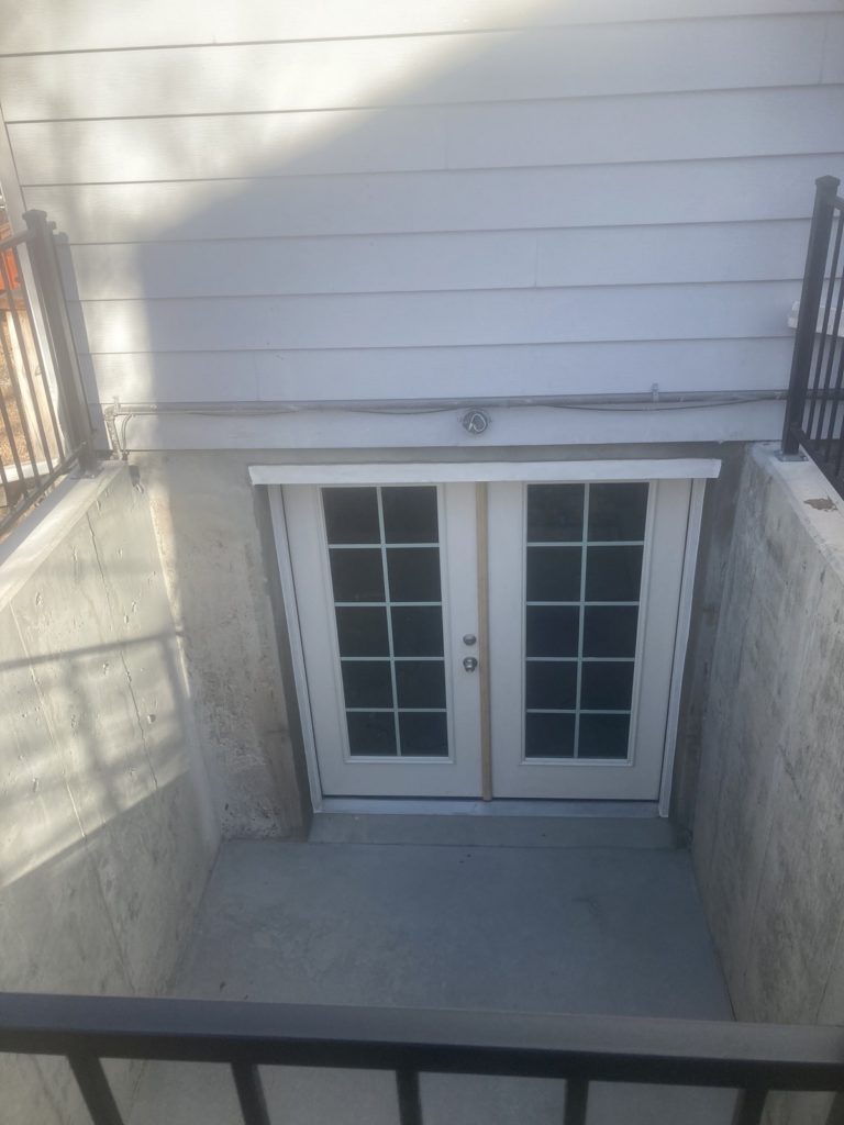 French doors installed as a basement egress door