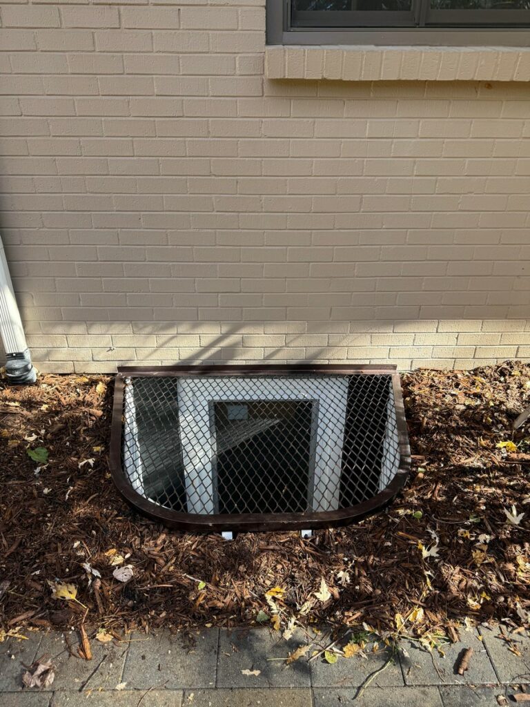 Denver Basement Egress Window Installation with Bronze Grate