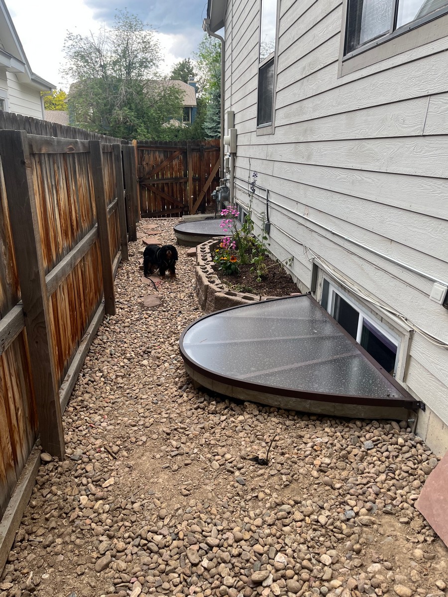 Replaced window well along a side yard in Arvada, CO